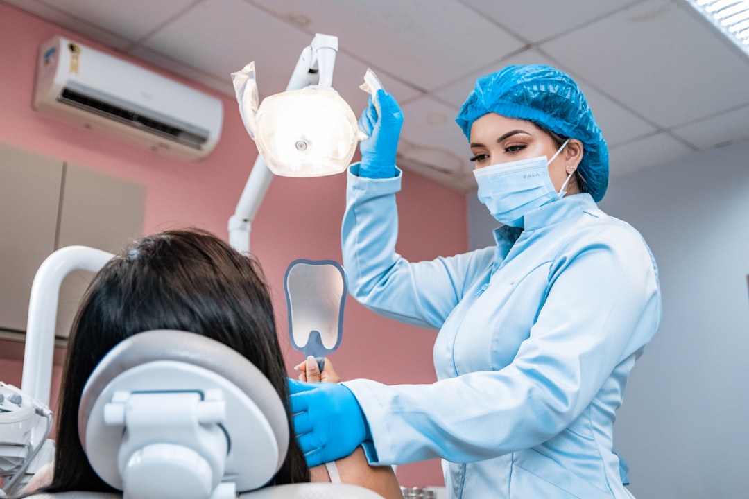 Dentist checking a patient's teeth in a bright Brampton dental clinic