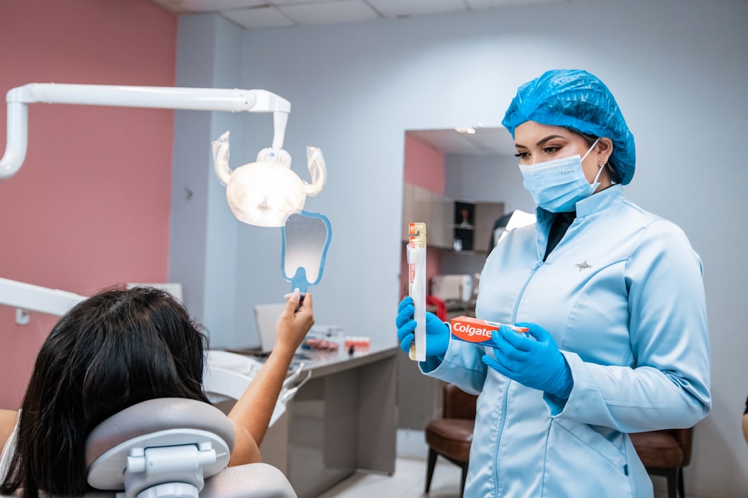 Dentist brushing a patient's teeth for preventive care