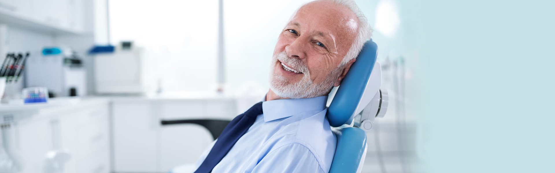 Old man looking happy at dental clinic in Ajax.