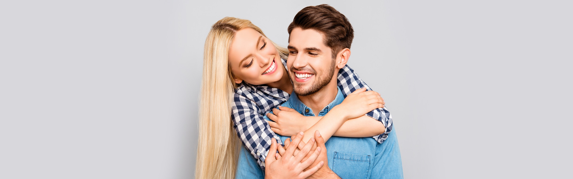 Smiling girl and boy flaunting healthy teeth.