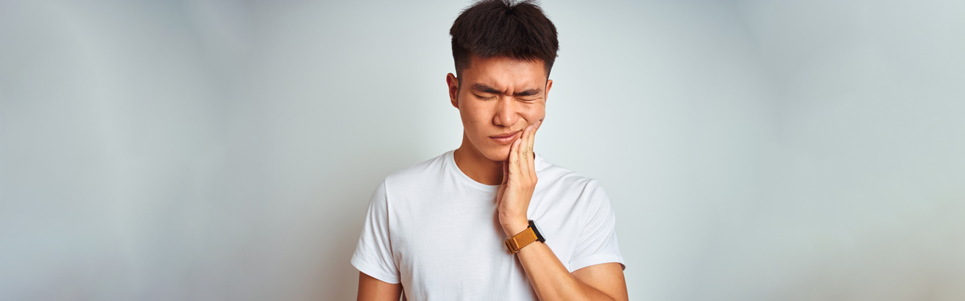 Boy having severe teeth pain
