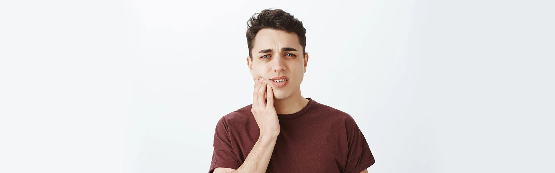 Boy suffering for toothache and looking to get a tooth extraction in Ajax, ON.