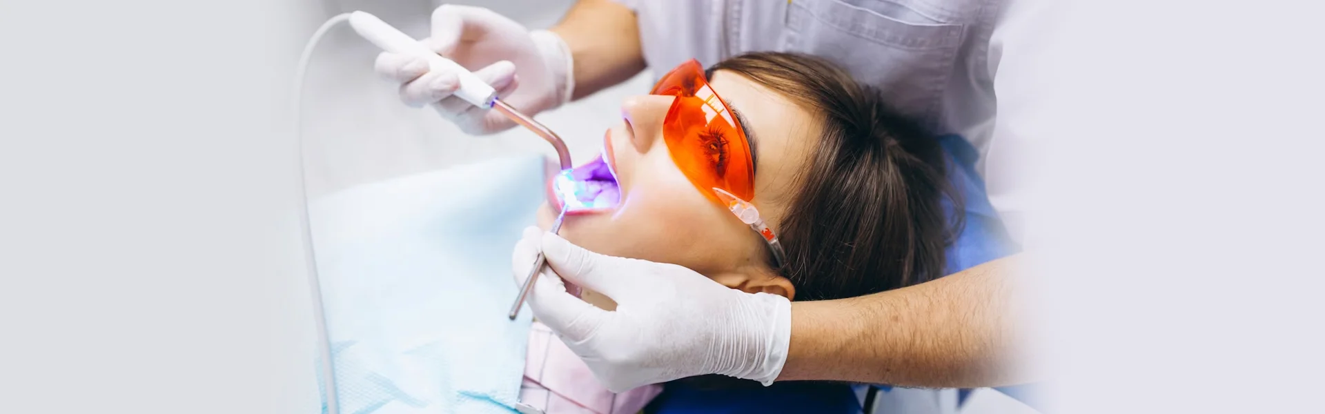 Girl under going dental treatment by a dentist in Ajax, ON.