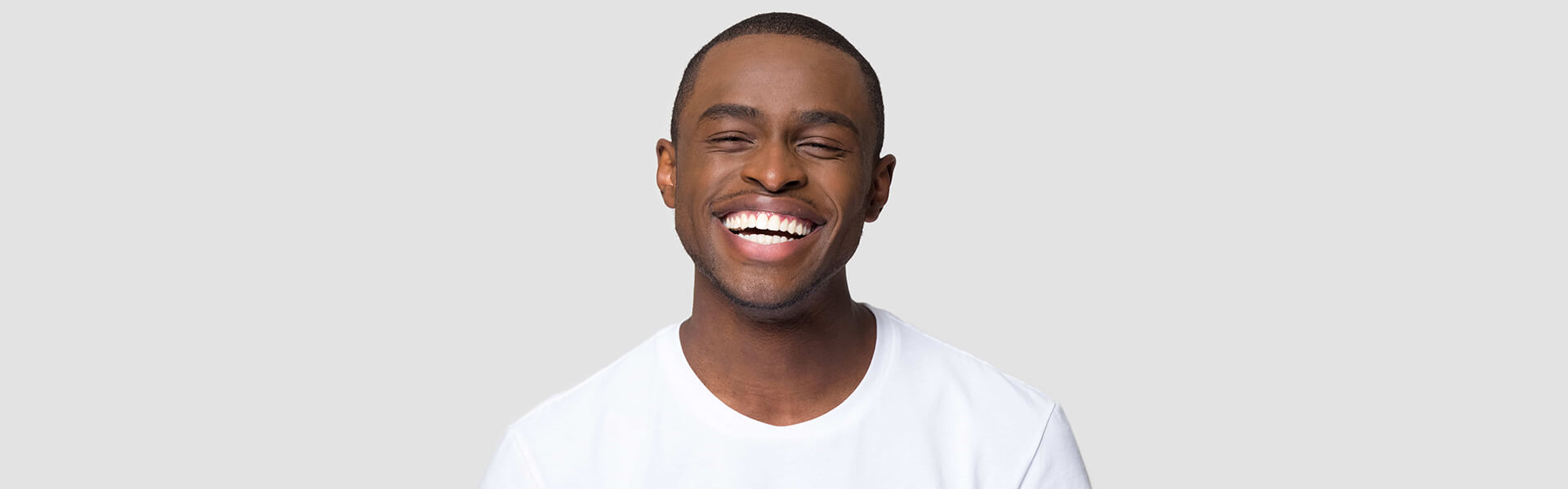 Boy smiling with bright teeth after cosmetic teeth whitening.