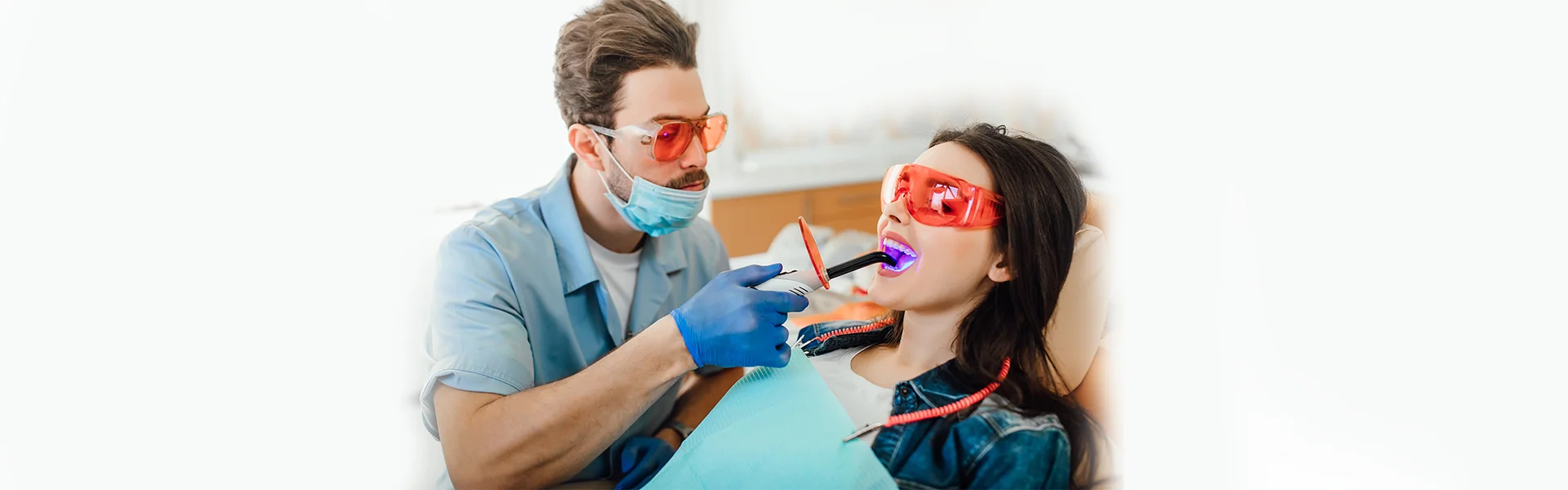 Dentist examining teeth of a dental patient.