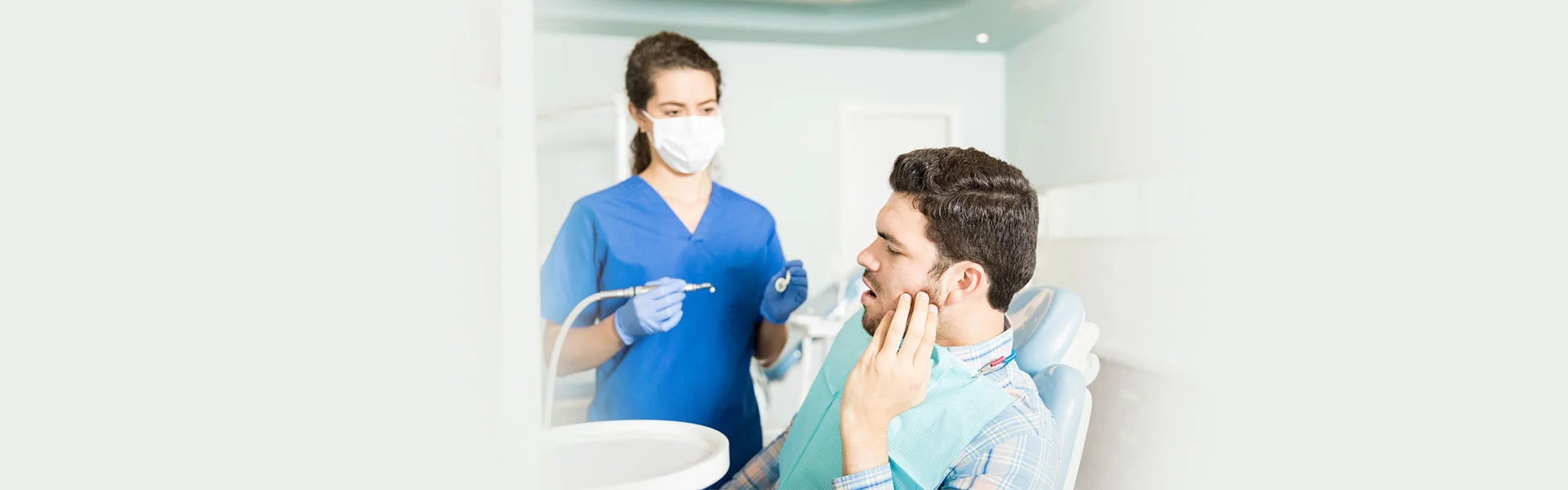 Dentist in Ajax taking care of teeth pain in patient on weekends.