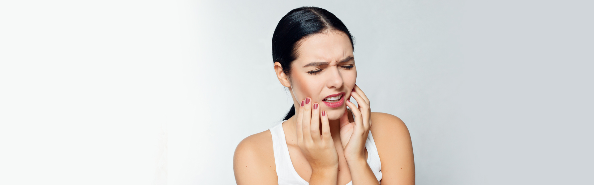 Girl suffering from severe tooth pain.